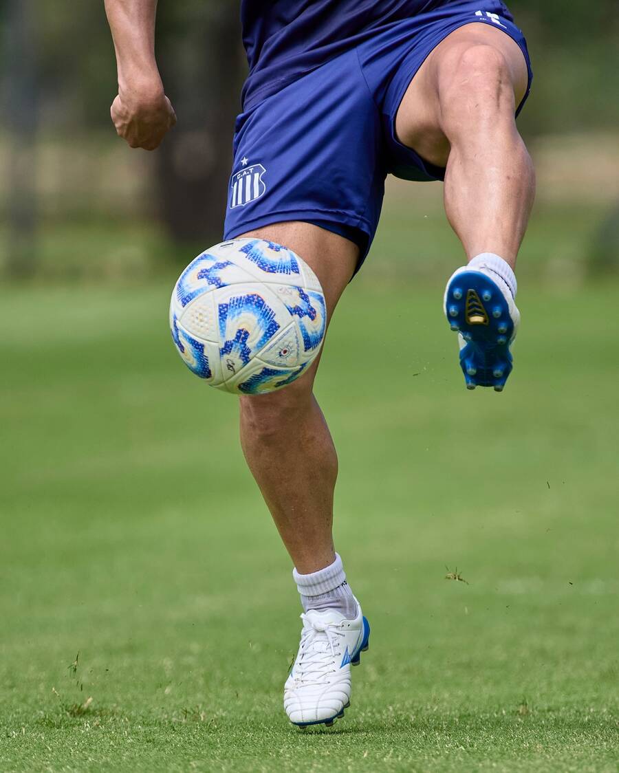 Player controlling a soccer ball on the field